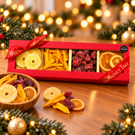 Walnut Tree luxury four-compartment dried fruit gift box featuring pineapple rings, dried mango strips, red dried fruits and orange slices, presented in red packaging with gold ribbon and Great Taste award badge against a warm festive Christmas background.