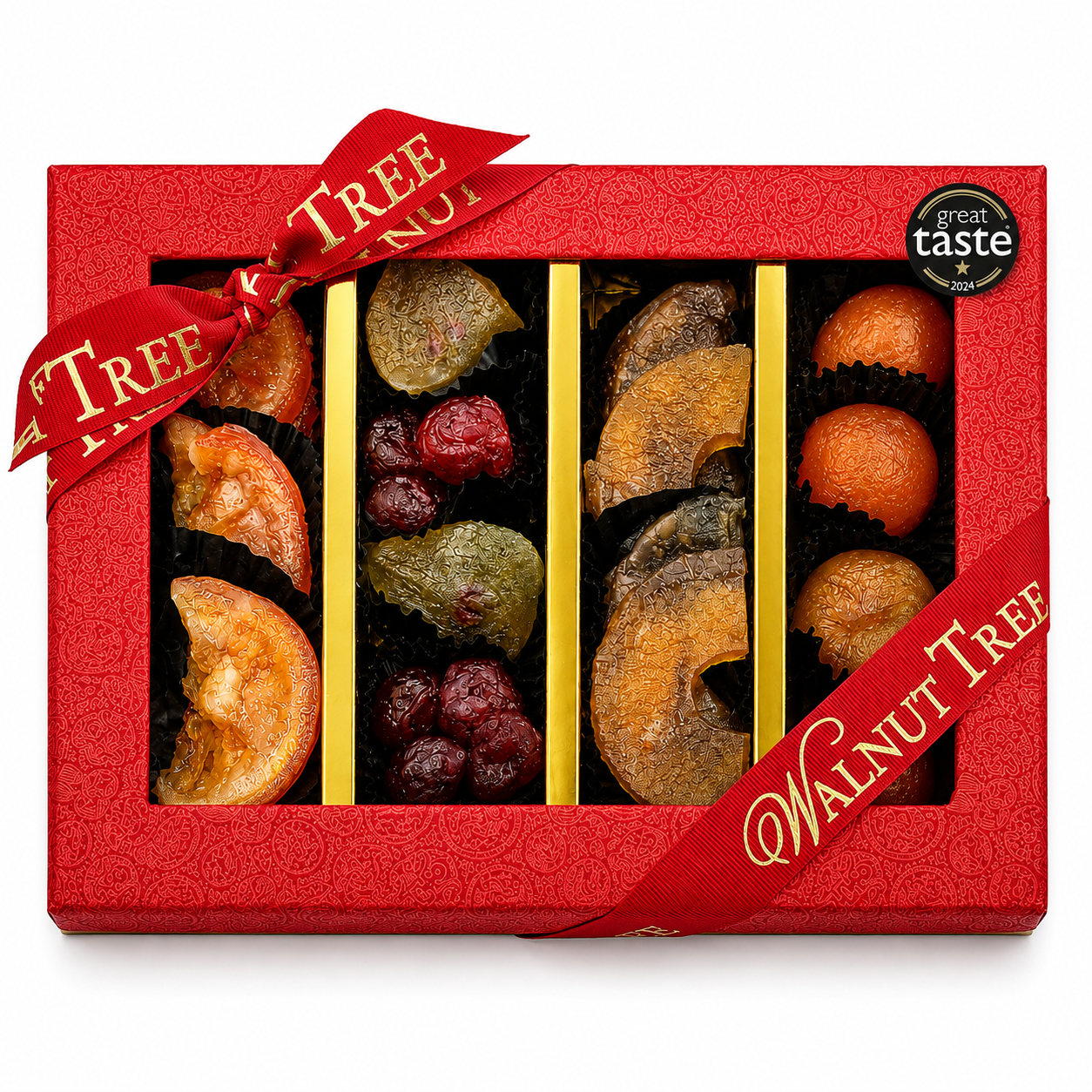 Walnut Tree luxury four-compartment glacé fruit gift box featuring assorted colourful candied fruits, presented in red packaging with gold ribbon, a wooden bowl of glacé fruits and warm festive Christmas lights.