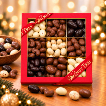 Walnut Tree luxury nine-compartment chocolate-coated nut gift box featuring assorted milk, dark and white chocolate-coated nuts, presented in red packaging with gold ribbon against a warm festive Christmas background.