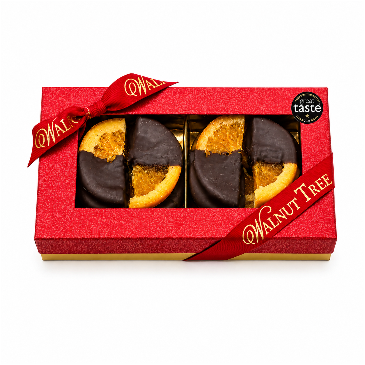 Walnut Tree luxury medium gift box of dark chocolate-dipped orange slices, presented in a red patterned box with metallic gold Walnut Tree ribbon, wooden bowl and elegant Christmas decorations.