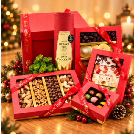 Walnut Tree luxury Christmas gift hamper featuring premium mixed nuts, dried fruits and assorted nougat in red and gold gift boxes, displayed with festive greenery and gold ornaments on a white background.