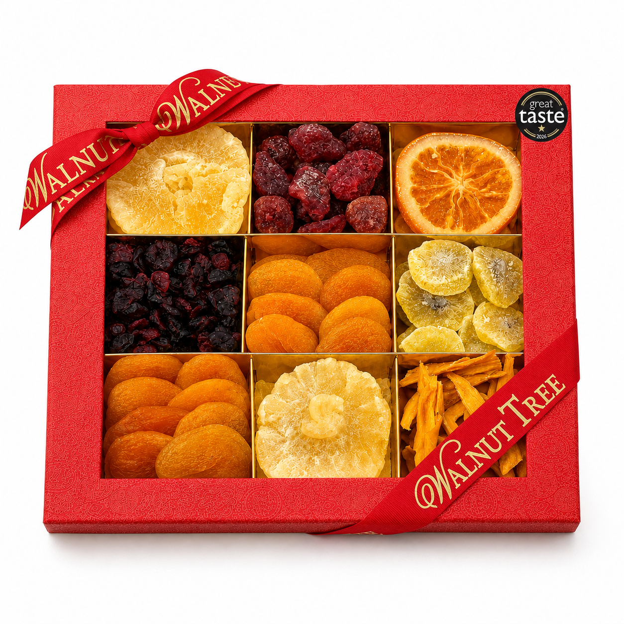 Walnut Tree luxury nine-compartment dried fruit gift box featuring assorted dried and glacé fruits, presented in red packaging with gold ribbon and Great Taste award badge against a warm Christmas background.