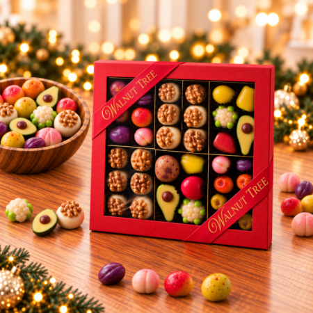 Walnut Tree luxury marzipan gift box featuring handcrafted marzipan fruits, vegetables and walnut-topped sweets, presented in a red ribboned gift box with a wooden bowl of marzipan and festive Christmas decorations