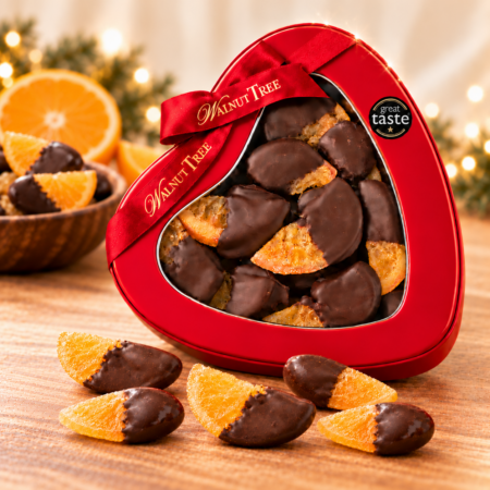 Walnut Tree dark chocolate dipped orange slices in a red heart-shaped gift tin with branded ribbon and Great Taste award, presented as a Christmas chocolate gift.