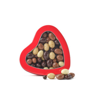 Assorted chocolate covered almonds in a red heart-shaped Walnut Tree gift box